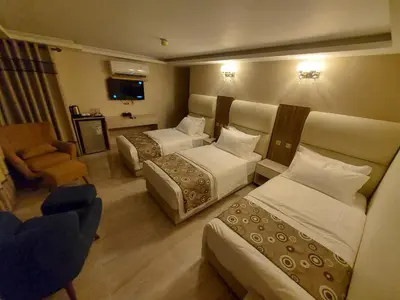 a hotel room with two beds and a chair at Jordan Seasons Hotel in Aqaba