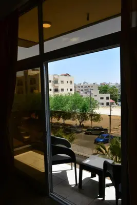 a window with a view of a parking lot at Rakeen Hotel in Amman