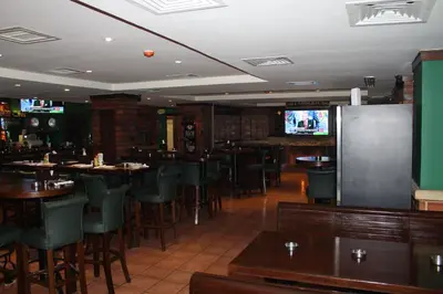 a restaurant with tables and chairs and a television at Post Boutique Hotel Amman in Amman