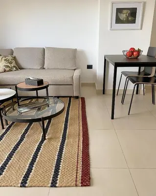 a living room with a couch and a table at Nu Fifty Two in Amman