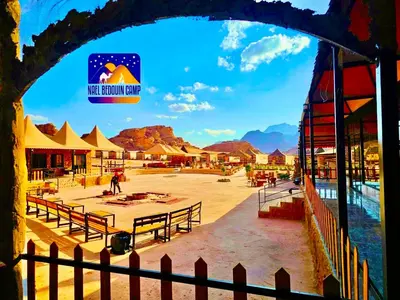 a view of a resort with tables and a fence at NAEL BEDOUIN lUXURY CAMP in Wadi Rum