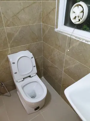 a bathroom with a toilet and a sink and a window at atoom studio in Jerash