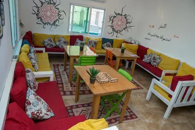a living room with a couch and tables and chairs at Hakaia Community in Aqaba