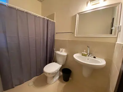 a bathroom with a toilet and a sink and a mirror at City Citadel Hotel,Amman in Amman