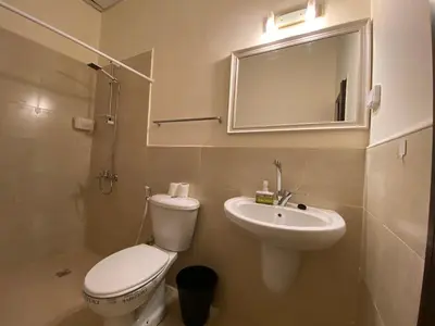 a bathroom with a toilet and a sink and a mirror at City Citadel Hotel,Amman in Amman