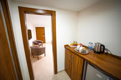 a room with a kitchen with a counter and a mirror at Joar Beach Hotel in Aqaba