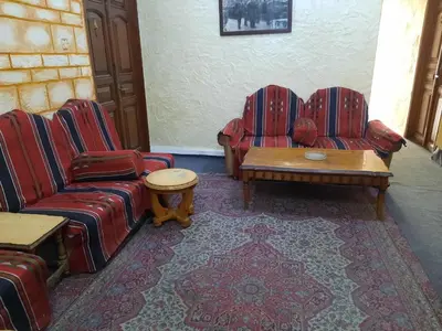 a living room with couches and a coffee table at Al Naser Hotel in Amman