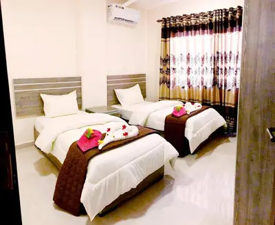 a hotel room with three beds with dolls on them at RAWA'AT ALAQABA in Aqaba