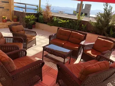 a group of chairs and tables on a patio at RAWA'AT ALAQABA in Aqaba