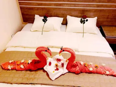 a bed with two red swans decorations on it at RAWA'AT ALAQABA in Aqaba