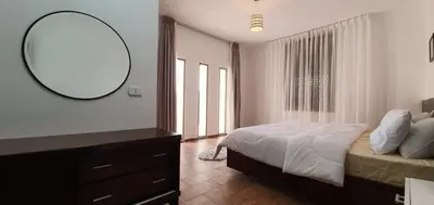 a bedroom with a bed and a mirror and a dresser at VILLA MARIA PETRA in Wadi Musa