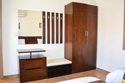 a dressing room with a mirror and a wooden cabinet at VILLA MARIA PETRA in Wadi Musa