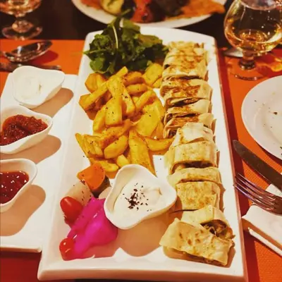 a white plate of food on a table at Mount Nebo Hotel & Restaurant Madaba City Center in Madaba