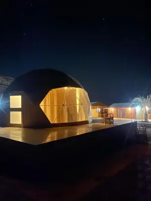a dome shaped building at night with lights at Wadi Rum Marcanã camp in Aqaba