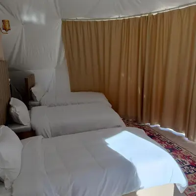 a bedroom with two beds in a tent at Wadi Rum Marcanã camp in Aqaba