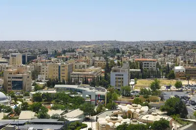 an aerial view of a city with buildings at Signia by Hilton in Amman