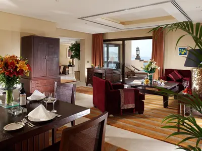 a living room with tables and chairs and a couch at InterContinental Aqaba by IHG in Aqaba