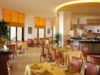 a dining room with tables and chairs in a restaurant at InterContinental Aqaba by IHG in Aqaba