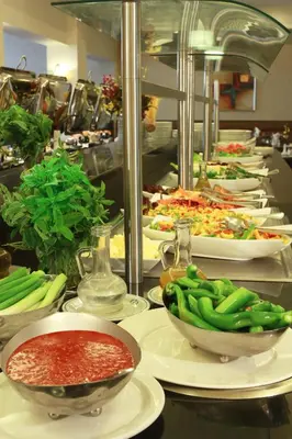 a buffet line of plates and bowls of food at Grand Palace Hotel in Amman