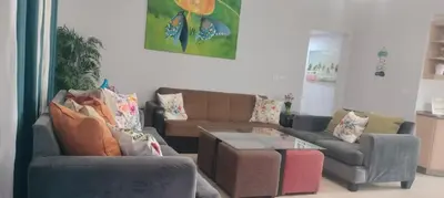 a living room with two couches and a coffee table at Gorgeous Pool View Apartment - Tala Bay Resort, Aqaba in Aqaba