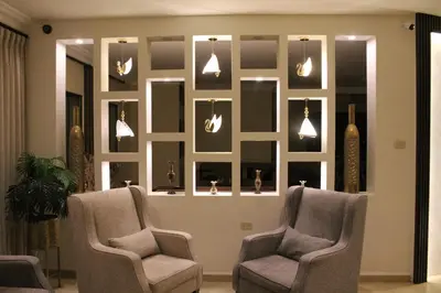 a living room with two chairs and a wall with mirrors at Salome Hotel in Madaba