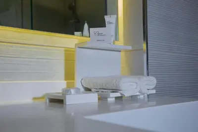 a bathroom with a towel rack and a box on the floor at Seas Hotel Amman in Amman