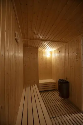 a sauna with a bench in the middle of it at Seas Hotel Amman in Amman