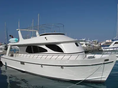 a white boat is docked in the water at The Royal Luxury Superior King in Amman
