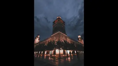 a large building with a clock tower at night at The Royal Luxury City Budget Visit in Amman