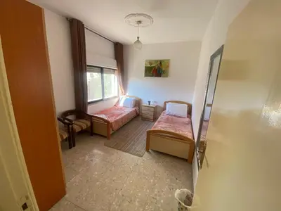 a room with two beds and a window at ROYAL Real ESTATE in Amman