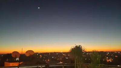 a view of the city at sunset from a rooftop at Saint John Hotel in Madaba