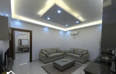 a living room with two couches and a tv at Amazing one Bedroom Apartment in Amman Elwebdah 8 in Amman