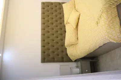 a bed in a room with a pillow on the wall at Amazing one Bedroom Apartment in Amman Elwebdah 5 in Amman