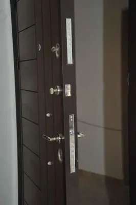 a wooden door with a mirror in a room at Amazing one Bedroom Apartment in Amman Elwebdah 6 in Amman