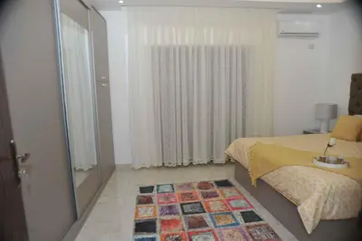 a bedroom with a bed and a window and a rug at Amazing one Bedroom Apartment in Amman Elwebdah 6 in Amman