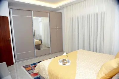 a bedroom with a bed and a large mirror at Amazing one Bedroom Apartment in Amman Elwebdah 6 in Amman