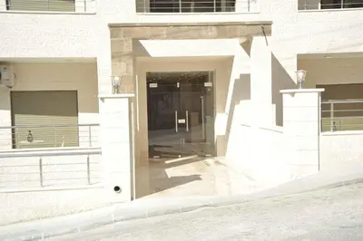 a building with a door in the middle of a street at Amazing one Bedroom Apartment in Amman Elwebdah 4 in Amman