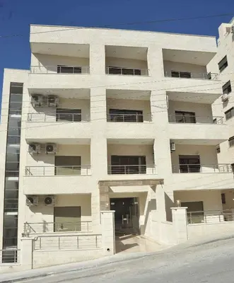 a large white building with a lot of windows at Amazing one Bedroom Apartment in Amman Elwebdah 4 in Amman