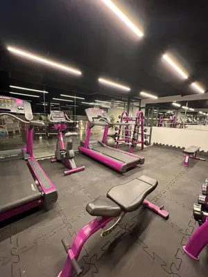 a gym with pink gym equipment in a room at Twins Boutique Hotel in Aqaba