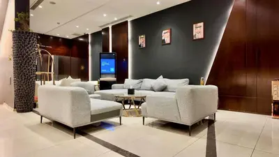 a living room with a couch and chairs and a table at Twins Boutique Hotel in Aqaba