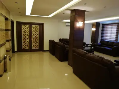 a waiting room with couches and chairs in a building at Seven Days Hotel in Irbid