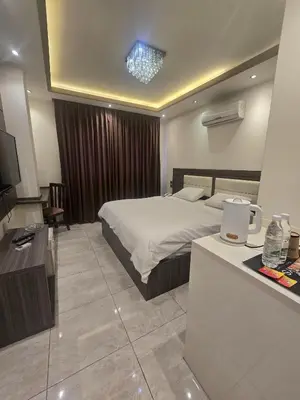 a hotel room with a bed and a television at Seven Days Hotel in Irbid