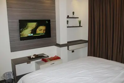 a bedroom with a bed and a flat screen tv at Seven Days Hotel in Irbid