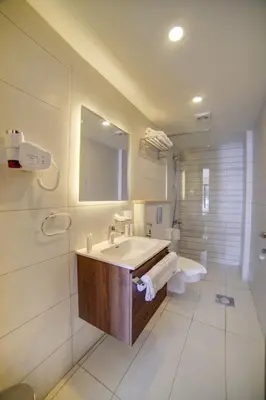 a bathroom with a sink and a toilet and a mirror at Sea view hotel in Aqaba