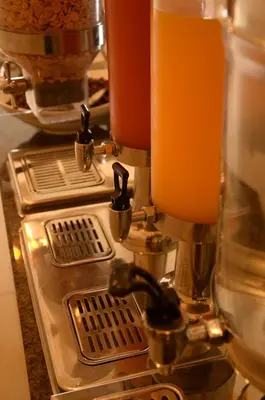 a close up of a coffee making machine at Mosaic City Hotel in Madaba