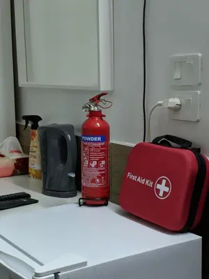 a red fire hydrant sitting on a counter next to a fire extinguisher at Full Panorama To Archaeological Site Jarash in Jerash