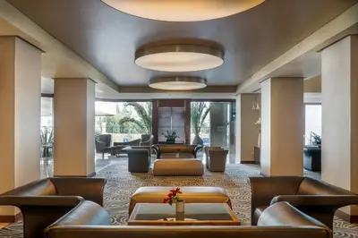 a lobby with couches and chairs and a table at Landmark Amman Hotel & Conference Center in Amman