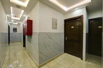a hallway with a door in a building at Downtown Hotel للعائلات فقط in Aqaba