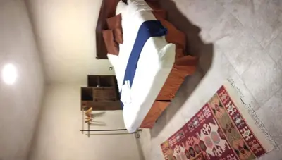 a white and blue umbrella hanging on a wall at Nonna Aisha B&B in Wadi Musa