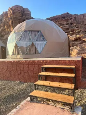 a yurt with a ladder and a wooden structure at Luxury Color Camp in Wadi Rum